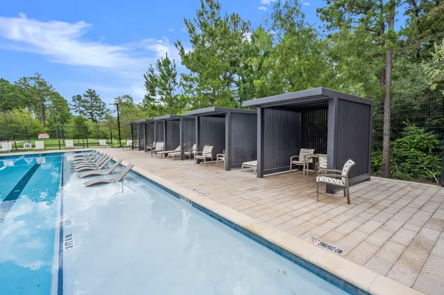 a swimming pool with chairs
