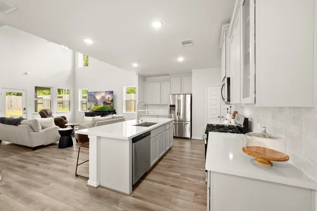 a large kitchen with a large counter top appliances and furniture
