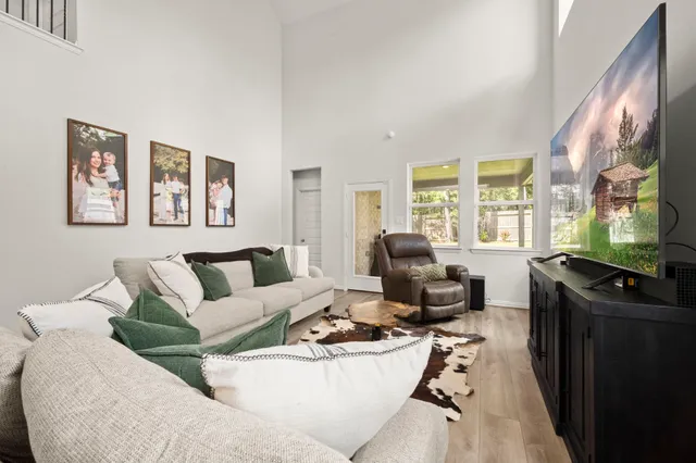 a living room with furniture window and a flat screen tv