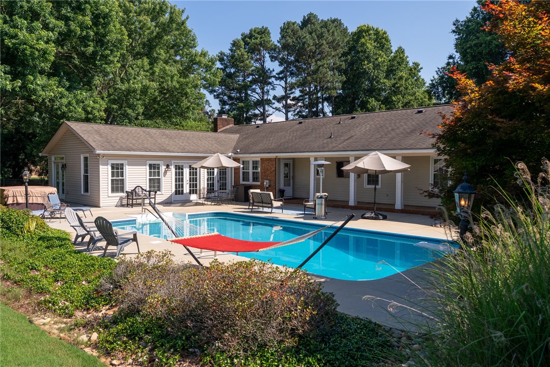 3513 Hopewell Road Anderson, SC 29621 - Photo 36 of 50 An inviting backyard oasis offers a sparkling pool for warm-weather relaxation and enjoyment.
