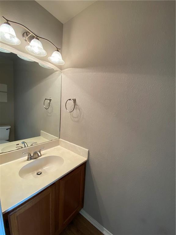 12325 Los Indios Trail, Unit 9 Austin, TX 78729 - Photo 13 of 30 Bathroom featuring vanity and dark wood-type flooring