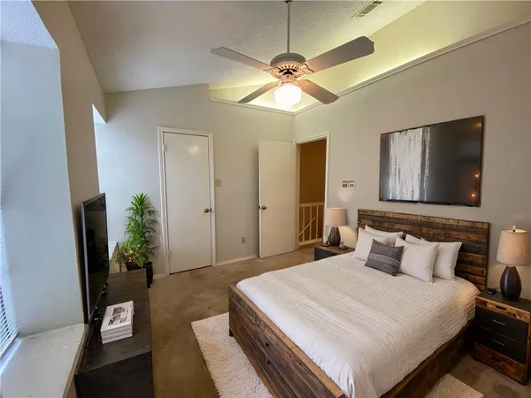 a bedroom with a bed and a potted plant