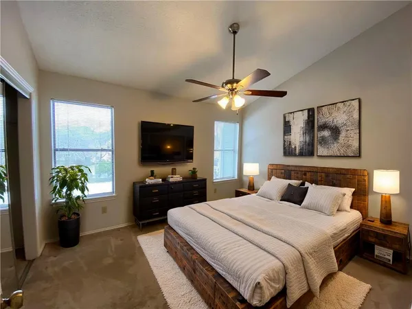 a bedroom with a bed and a flat screen tv