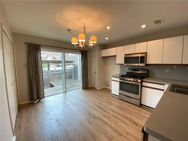 a kitchen with stainless steel appliances a refrigerator microwave and stove