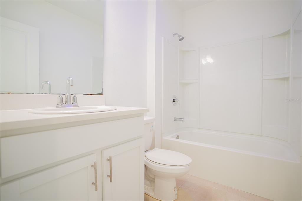 280 Citrine Loop Kissimmee, FL 34758 - Photo 13 of 25 a bathroom with a sink a toilet and shower