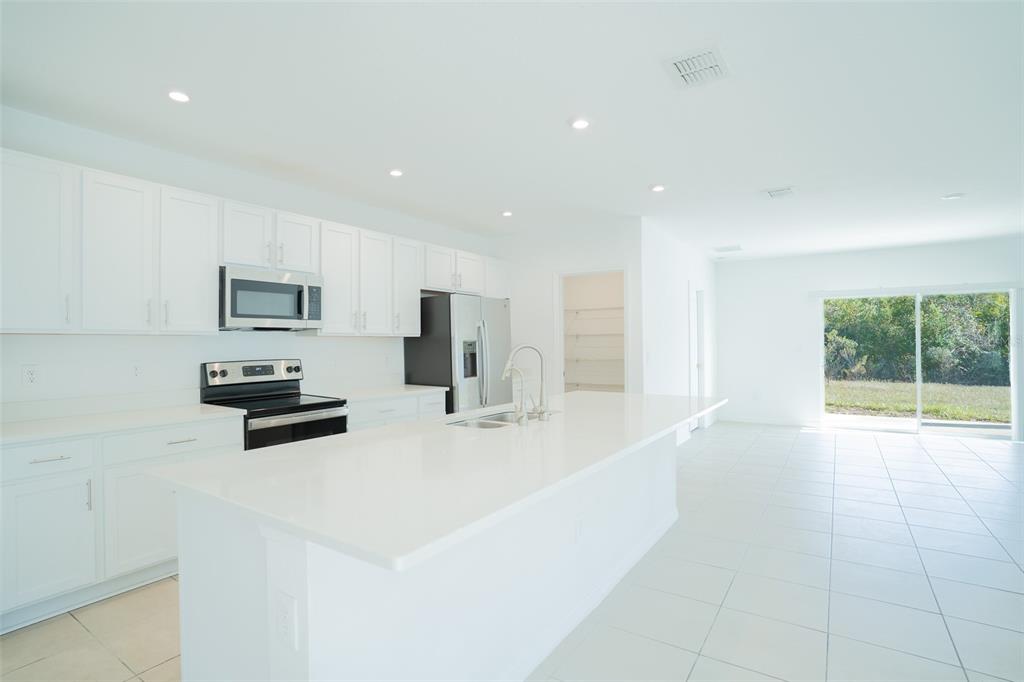 280 Citrine Loop Kissimmee, FL 34758 - Photo 6 of 25 a large white kitchen with a large window