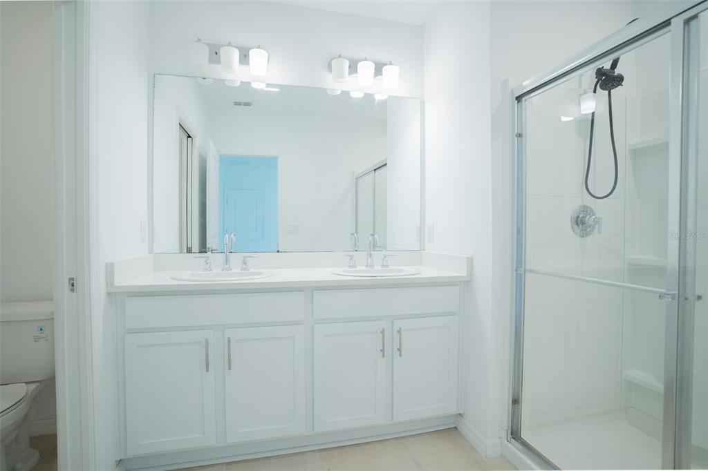 280 Citrine Loop Kissimmee, FL 34758 - Photo 8 of 25 a bathroom with a double vanity sink mirror and shower