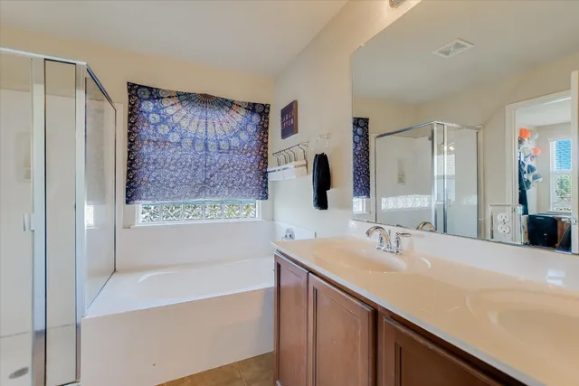 a bathroom with a bathtub sink and mirror