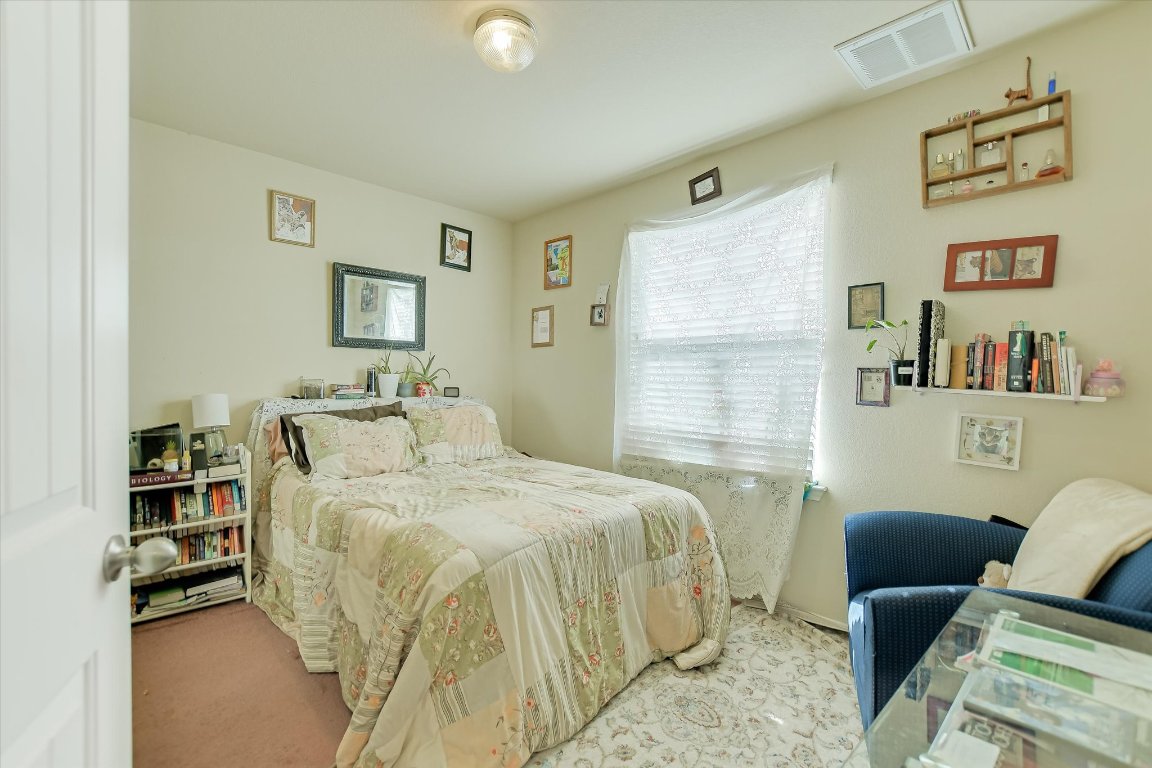 1700 Zilker Drive Cedar Park, TX 78613 - Photo 12 of 19 a bedroom with a bed couch and a window