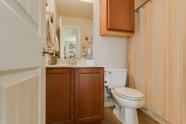 a bathroom with a sink a toilet and mirror
