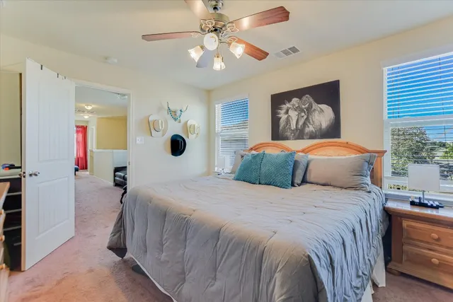 a bedroom with a large bed and a chandelier