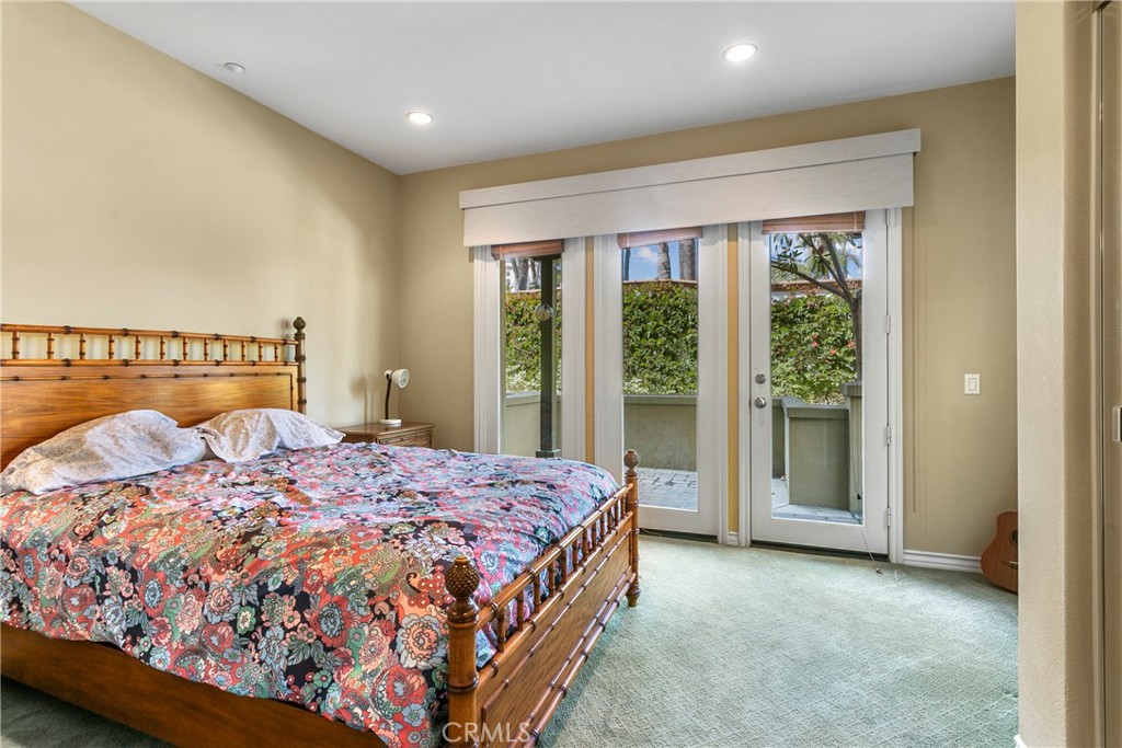 21331 Veleta Circle Huntington Beach, CA 92648 - Photo 11 of 14 a bedroom with a large bed and a large window