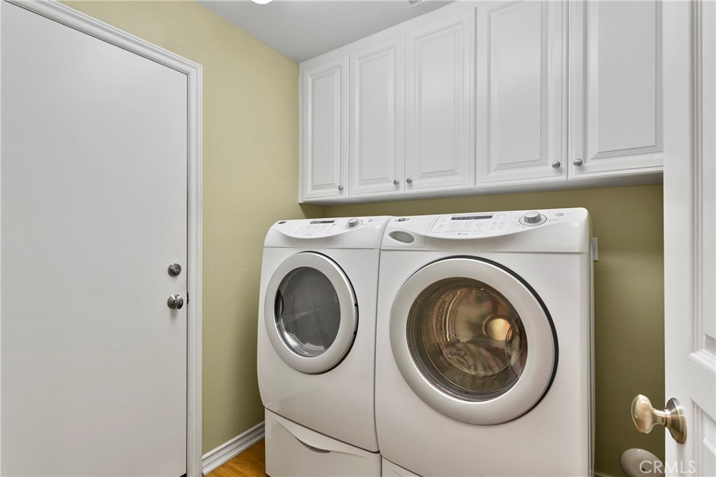 21331 Veleta Circle Huntington Beach, CA 92648 - Photo 13 of 14 a close view of a utility room with dryer and washer
