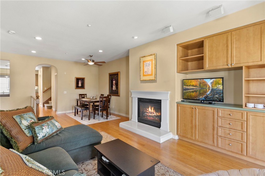21331 Veleta Circle Huntington Beach, CA 92648 - Photo 2 of 14 a living room with furniture a fireplace and a flat screen tv