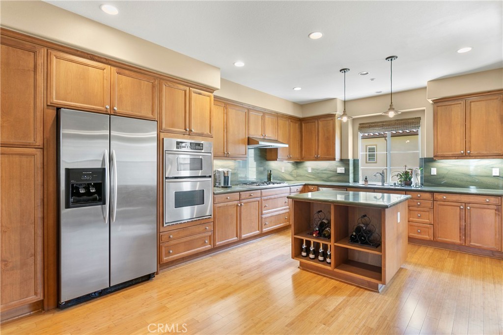 21331 Veleta Circle Huntington Beach, CA 92648 - Photo 4 of 14 a kitchen with stainless steel appliances granite countertop a refrigerator a sink and a stove