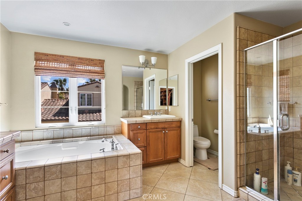 21331 Veleta Circle Huntington Beach, CA 92648 - Photo 9 of 14 a bathroom with a granite countertop sink mirror and bathtub