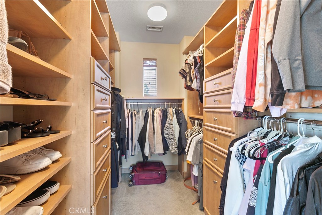 21331 Veleta Circle Huntington Beach, CA 92648 - Photo 10 of 14 a view of walk in closet with clothes and shoes