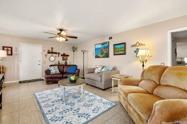 a living room with furniture and a rug