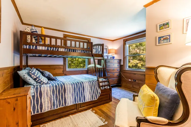 a dining room with furniture and large windows