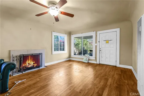 a view of an empty room with a fireplace and a window