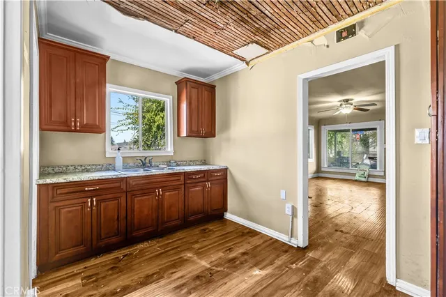 a kitchen with granite countertop a sink and cabinets