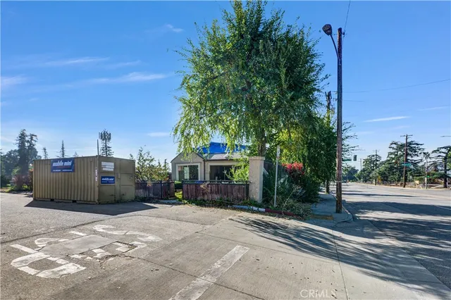 a front view of a building with a garden