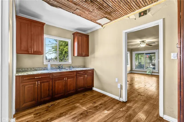 a kitchen with granite countertop a sink and cabinets