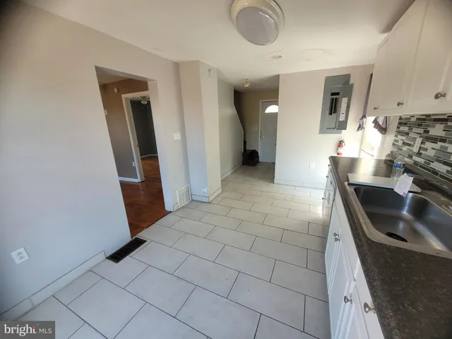 a kitchen with granite countertop a sink and a stove
