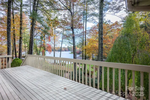 a balcony with wooden floor and fence