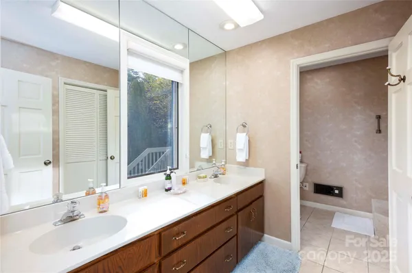 a bathroom with a sink double vanity and a mirror