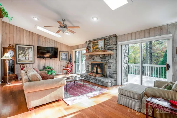 a living room with furniture a flat screen tv and a fireplace