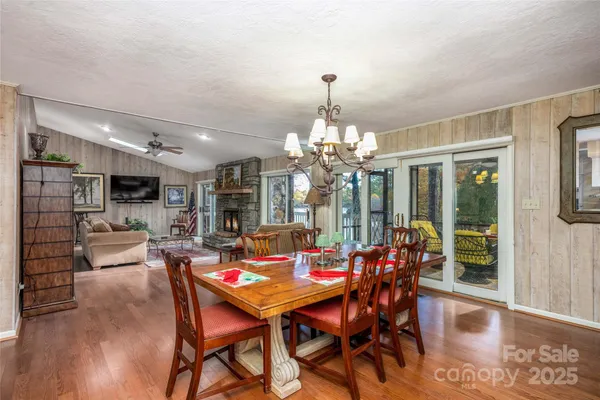 a view of a dining room with furniture wooden floor and chandelier