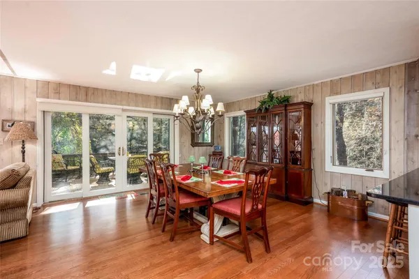 a dining room with furniture window and wooden floor