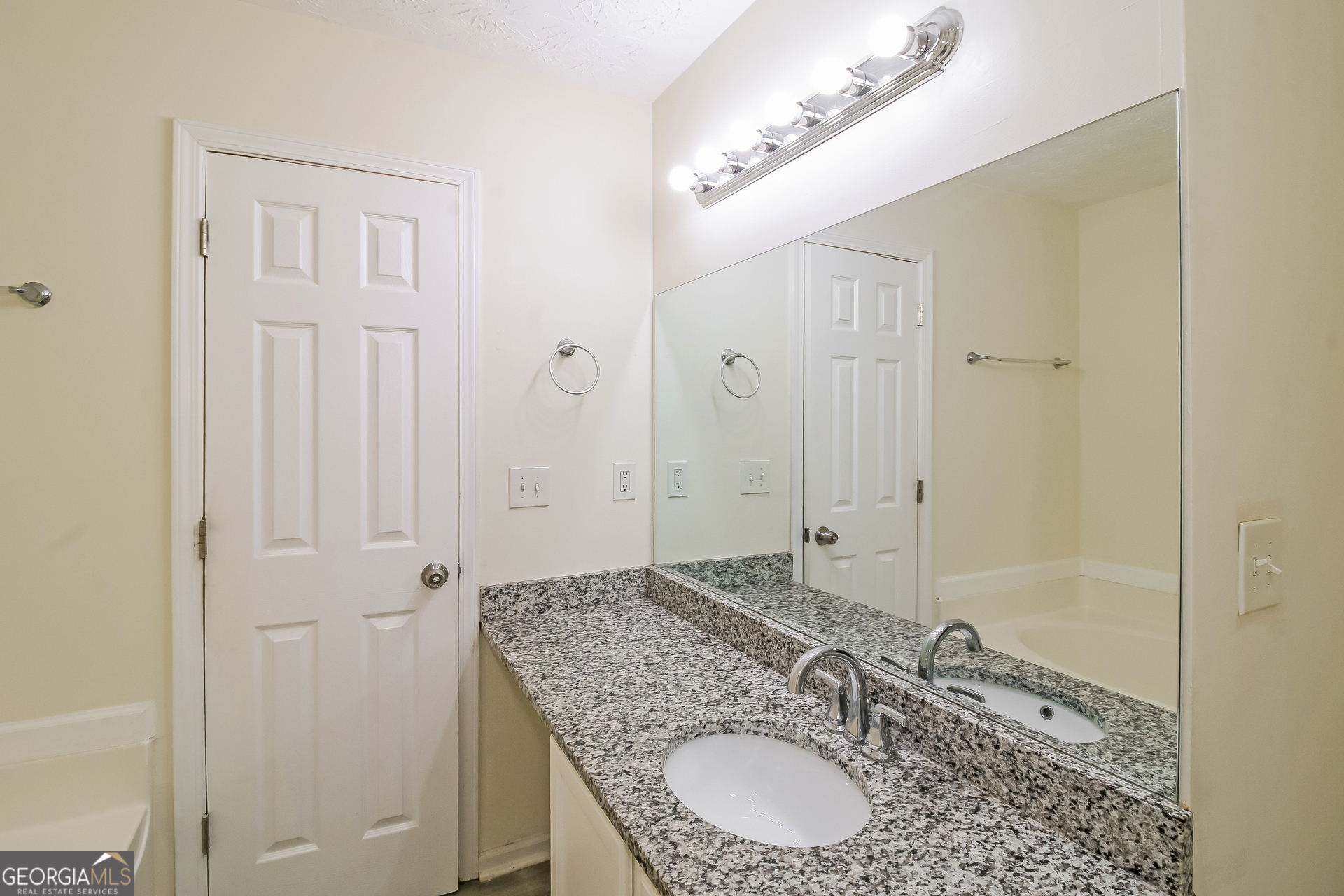 7023 Setters Way Lithonia, GA 30038 - Photo 11 of 21 a bathroom with a granite countertop sink a mirror and a shower