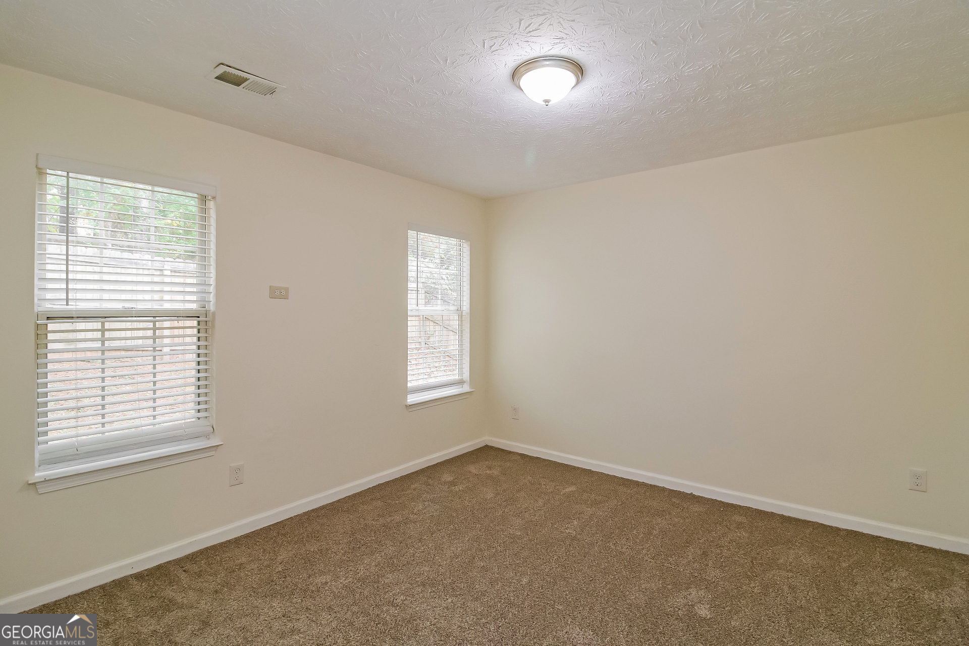 7023 Setters Way Lithonia, GA 30038 - Photo 15 of 21 an empty room with windows