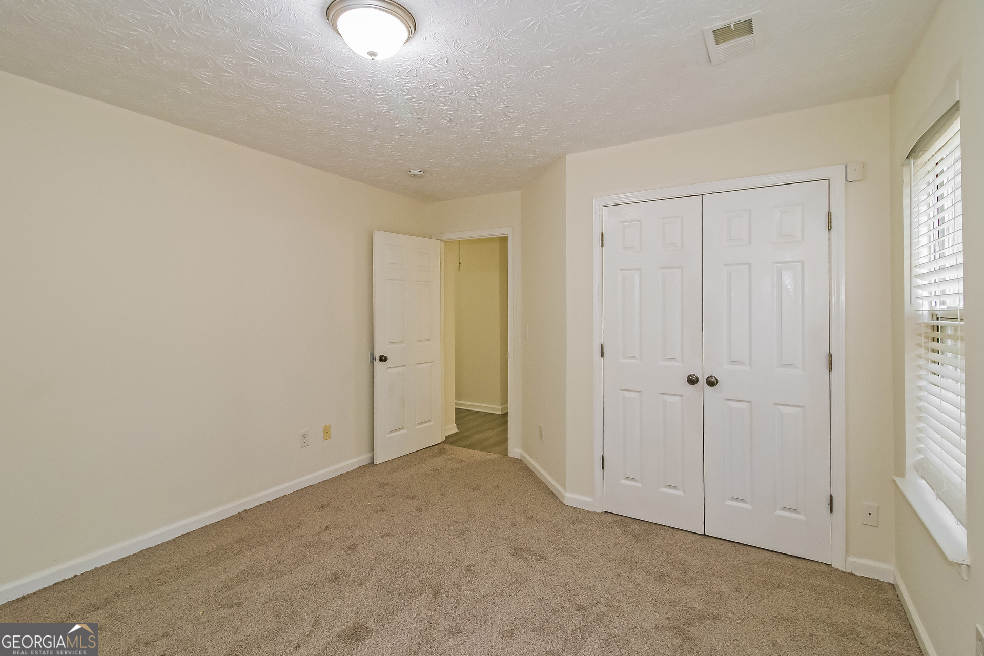 7023 Setters Way Lithonia, GA 30038 - Photo 16 of 21 a view of an empty room and window