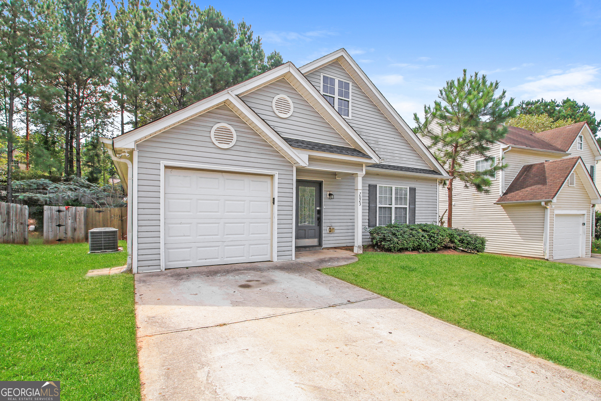 7023 Setters Way Lithonia, GA 30038 - Photo 3 of 21 a front view of a house with a garden
