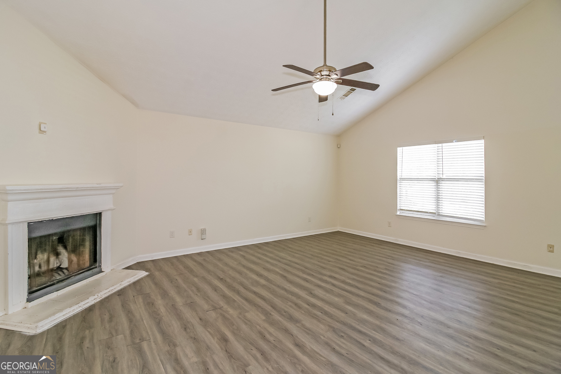 7023 Setters Way Lithonia, GA 30038 - Photo 4 of 21 an empty room with windows fireplace and sink