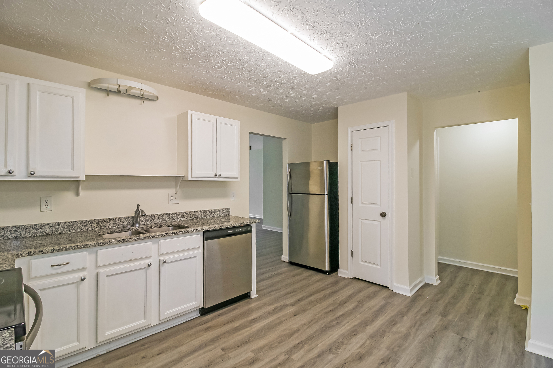 7023 Setters Way Lithonia, GA 30038 - Photo 8 of 21 a kitchen with stainless steel appliances granite countertop a refrigerator and cabinets