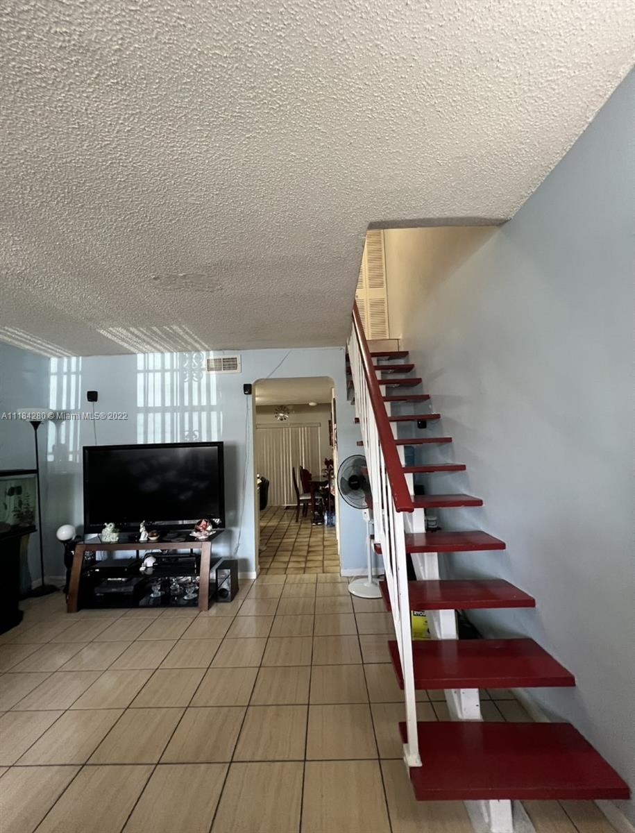 5866 West 18th Avenue, Unit 3023 Hialeah, FL 33012 - Photo 3 of 10 a room with furniture and a flat screen tv