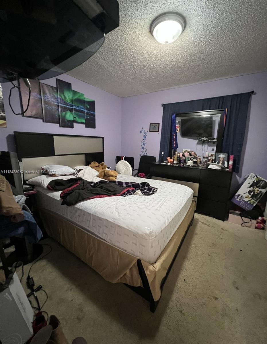 5866 West 18th Avenue, Unit 3023 Hialeah, FL 33012 - Photo 8 of 10 a bedroom with bed and window