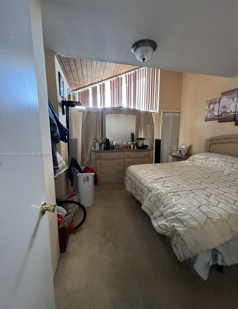 5866 West 18th Avenue, Unit 3023 Hialeah, FL 33012 - Photo 10 of 10 a bedroom with bed and window