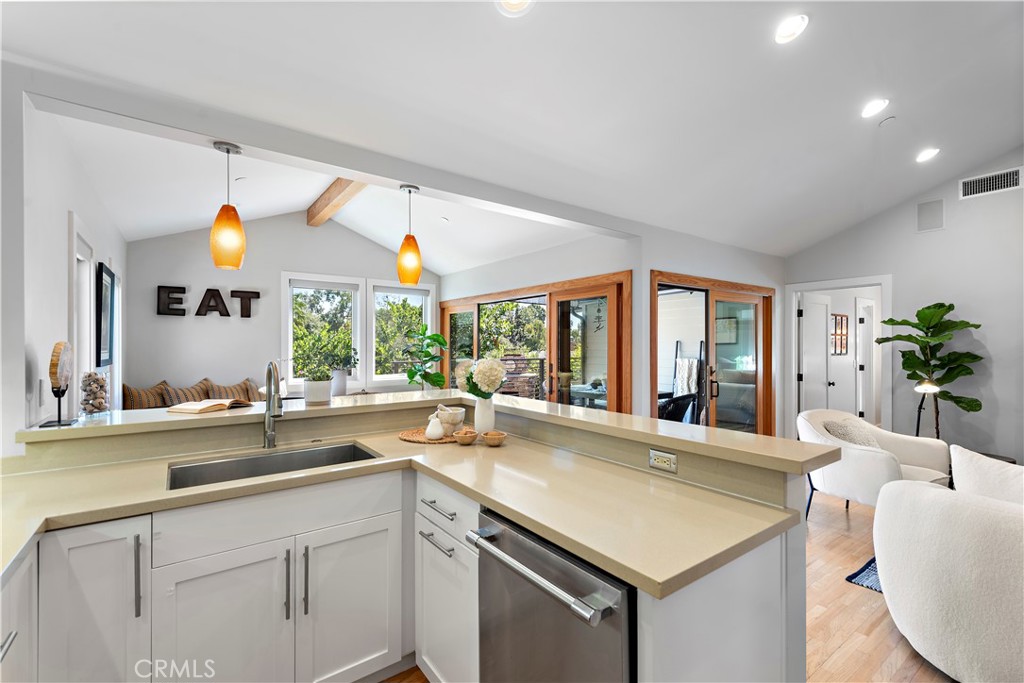 461 Shadow Lane Laguna Beach, CA 92651 - Photo 11 of 54 a view of center island with a sink and large windows
