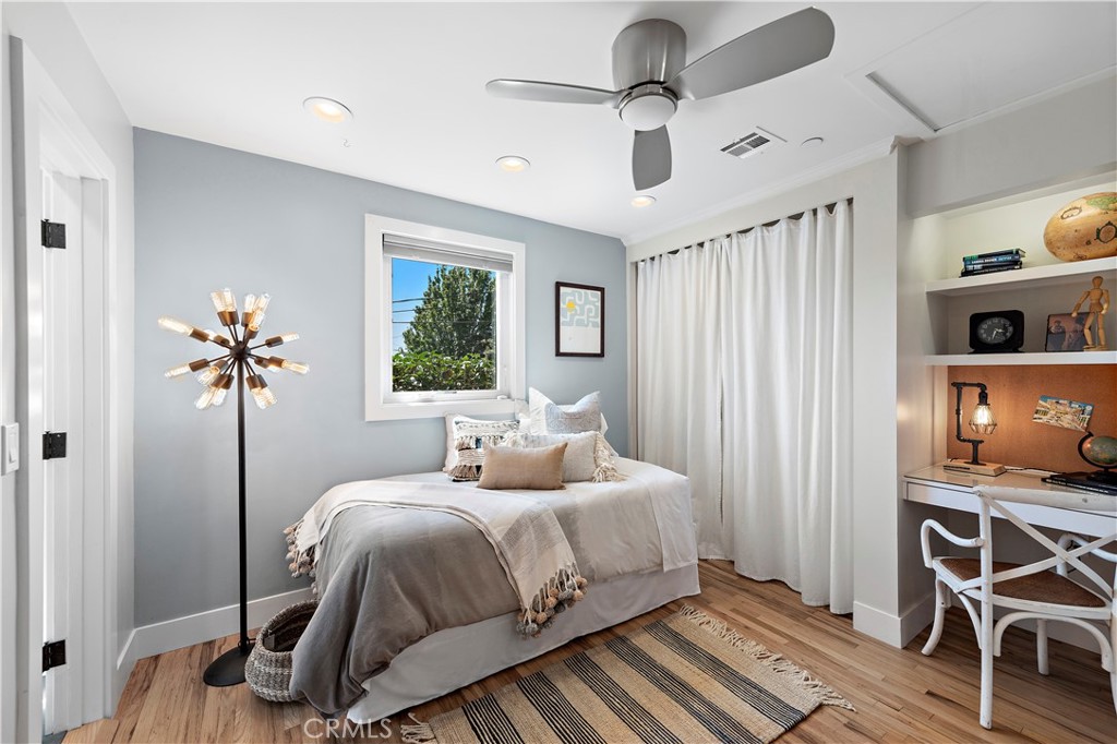 461 Shadow Lane Laguna Beach, CA 92651 - Photo 18 of 54 a bedroom with a bed and a chandelier