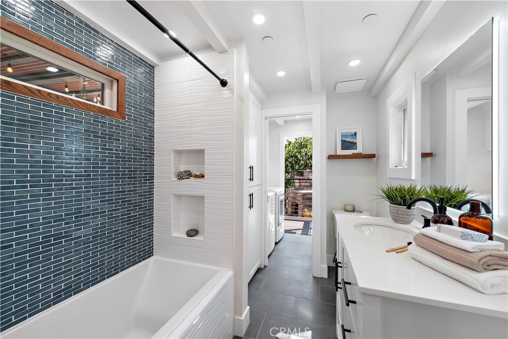 461 Shadow Lane Laguna Beach, CA 92651 - Photo 19 of 54 a bathroom with a sink a bathtub and shower