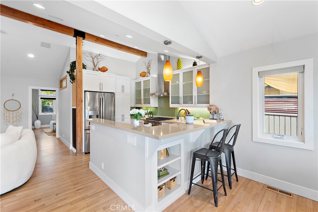 461 Shadow Lane Laguna Beach, CA 92651 - Photo 9 of 54 a kitchen with stainless steel appliances a dining table chairs and wooden floor