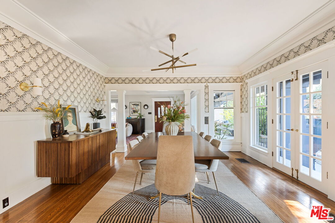 375 North Ridgewood Place Los Angeles, CA 90004 - Photo 13 of 56 a living room with furniture a flat screen tv and a floor to ceiling window