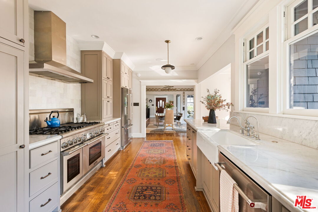 375 North Ridgewood Place Los Angeles, CA 90004 - Photo 22 of 56 a large kitchen with stainless steel appliances granite countertop a lot of counter space and a sink
