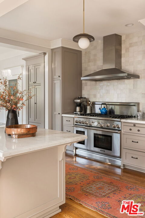 375 North Ridgewood Place Los Angeles, CA 90004 - Photo 25 of 56 a kitchen with stainless steel appliances granite countertop a stove and a sink with cabinets