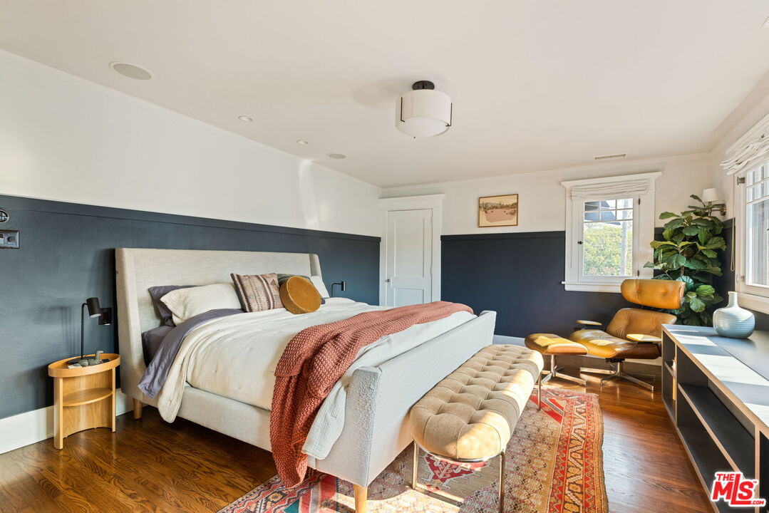 375 North Ridgewood Place Los Angeles, CA 90004 - Photo 28 of 56 a bedroom with a bed and wooden floor